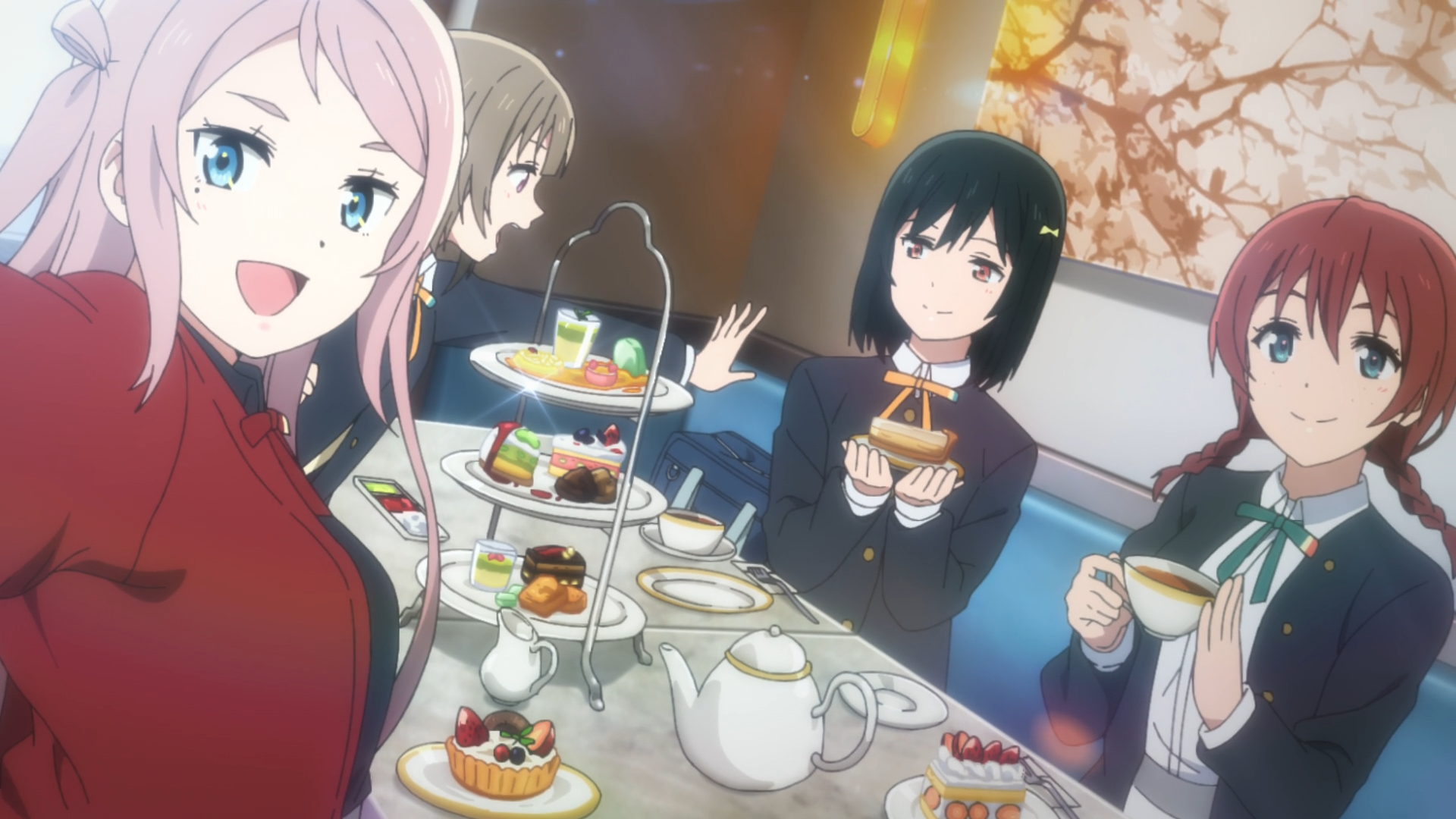 Lanzhu Zhong sitting with Kasumi Nakasu, Shioriko Mifune, and Emma Verde at a table in front of a dessert.