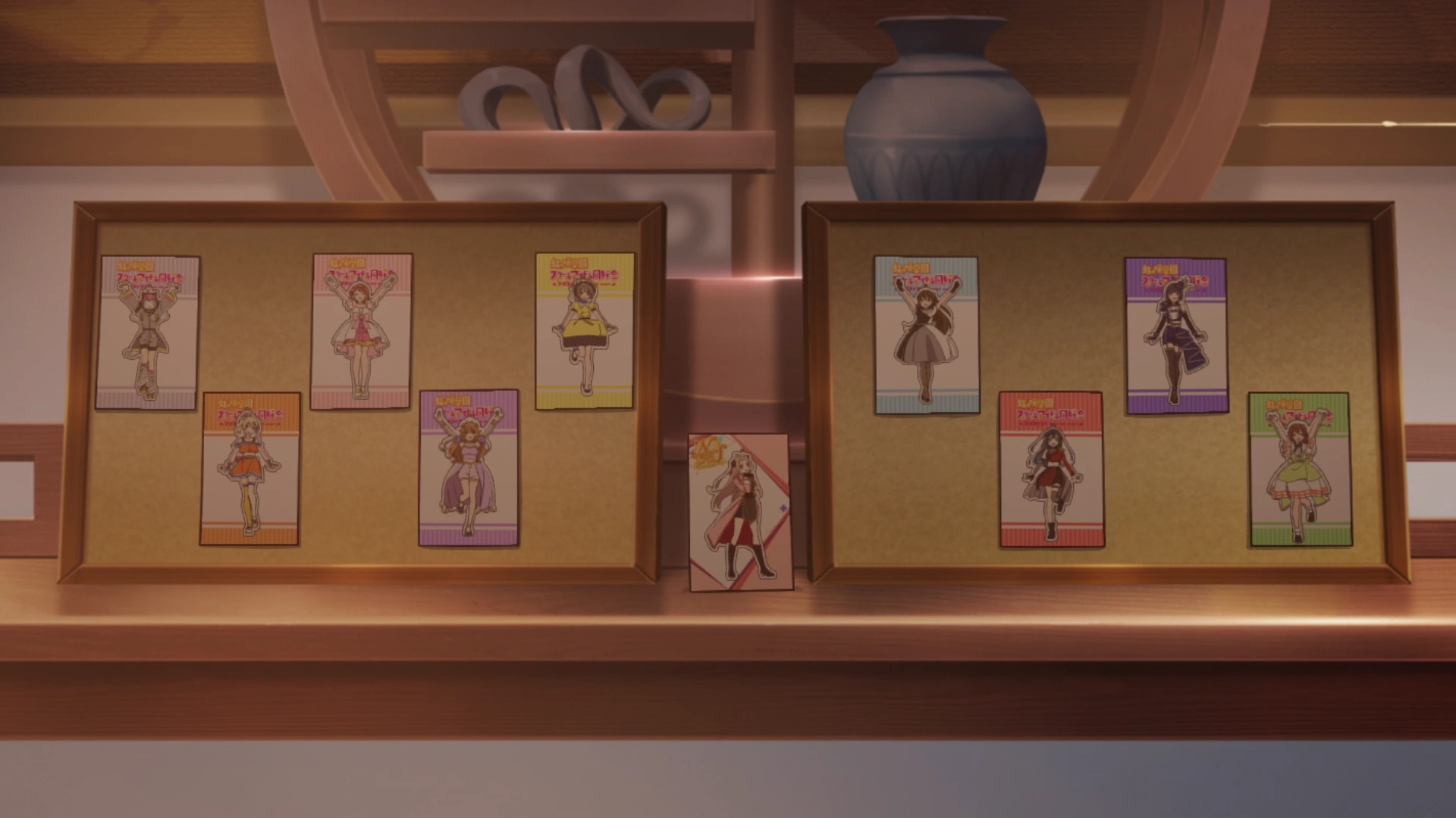 Lanzhu Zhong's Nijigasaki School Idol Club merch being displayed in her apartment. Lanzhu Zhong's own portrait in the middle.